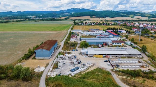 Aerial view of warehouses and halls in Dulov with surrounding nature.
