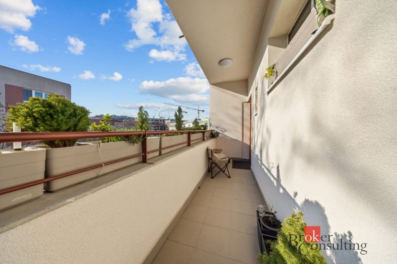 A balcony of a 3-room apartment with greenery and a view of Šancová Street, Bratislava-Nové Mesto.