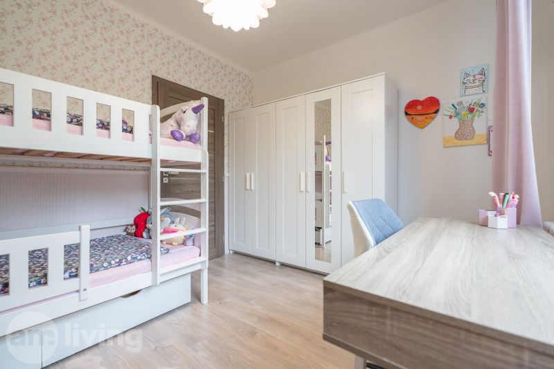 Children's room with a bunk bed, wardrobe, and wooden decor flooring in a 3-room apartment.
