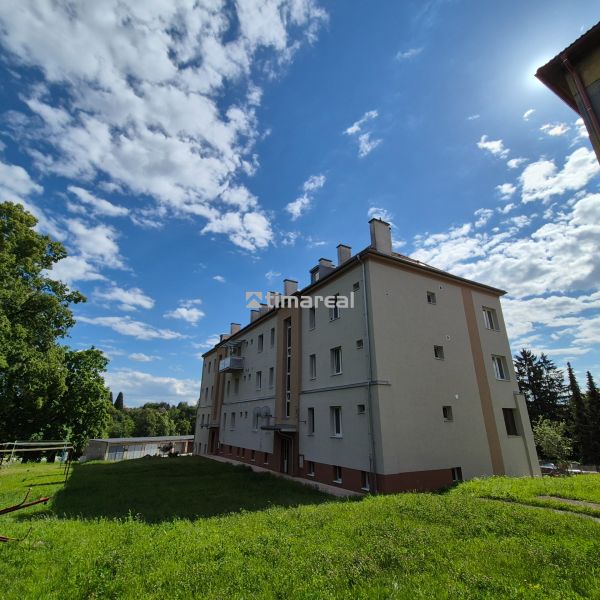 An apartment building with a lawn and a clear sky on Kpt. Uhra Street in Myjava.