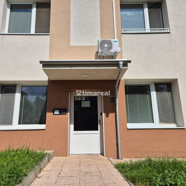 Entrance to the studio apartment on Kpt. Uhra Street, Myjava, with air conditioning on the facade.