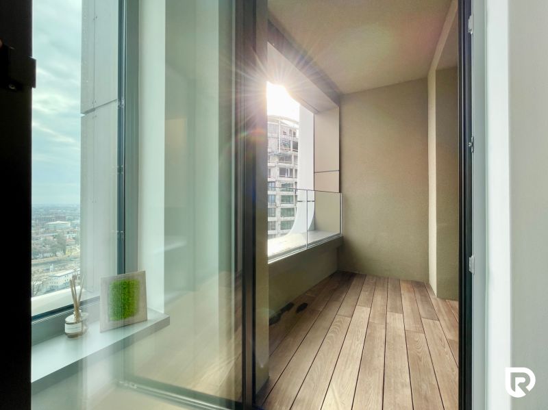 A balcony with a view in a 2-room apartment, floor with wooden decor.