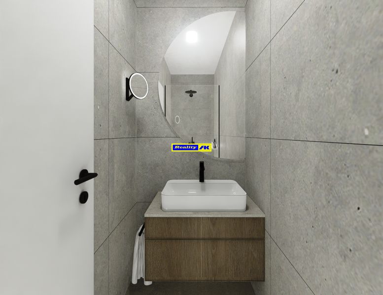 A bathroom with gray tiles and a sink in a 2-room apartment.