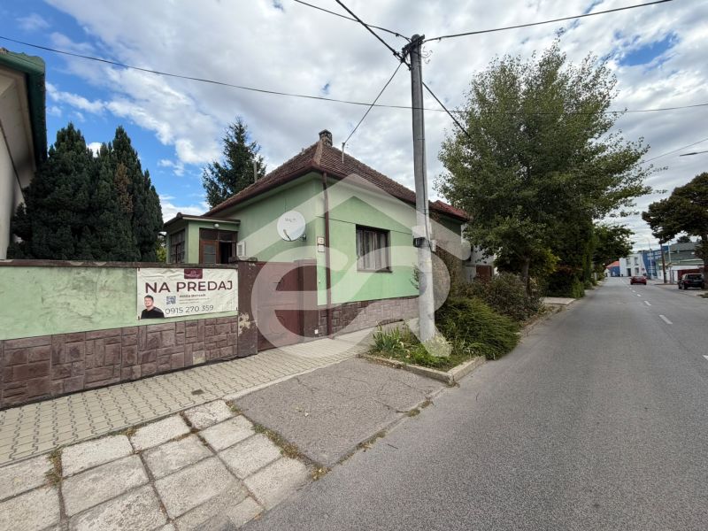A family house on Šulekova Street in Nové Zámky, surrounded by greenery and a sidewalk.