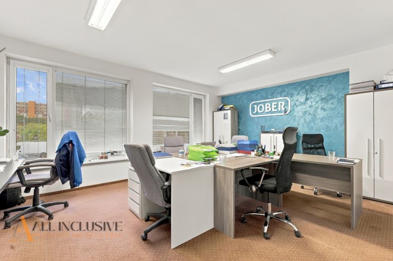 Offices equipped for work including desks, chairs, and cabinets, with flooring decor.