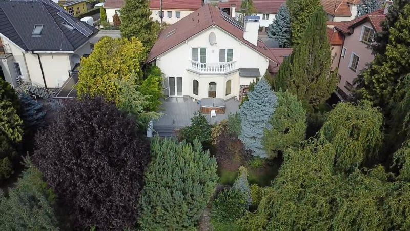 A family house in Trenčianske Stankovce surrounded by lush greenery and a garden.