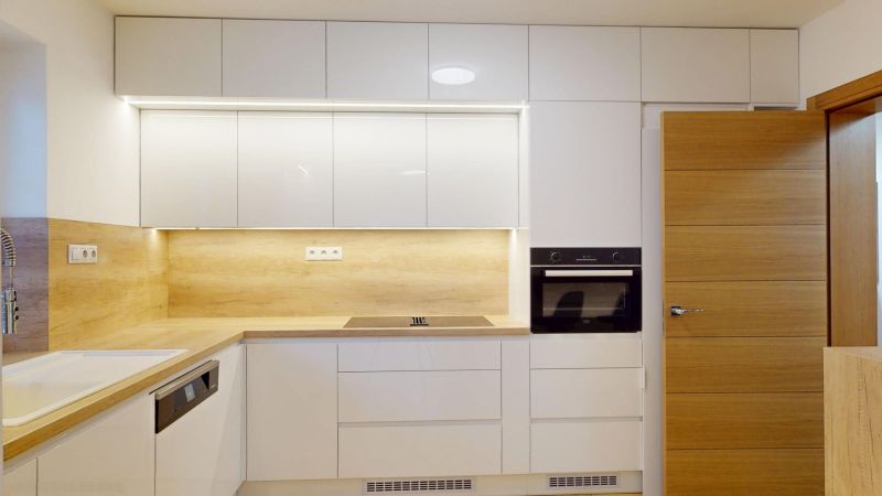A kitchen unit in a family house with a wood decor and built-in appliances.