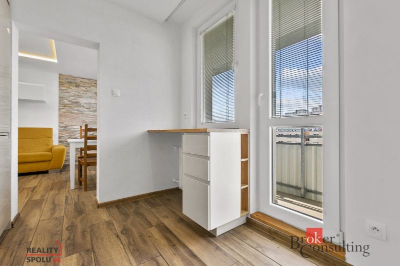 Interior of a 5 or more room apartment with wood-patterned flooring and a balcony.
