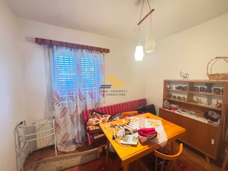 Dining room in a family house with furniture and decorations, wooden decor flooring.