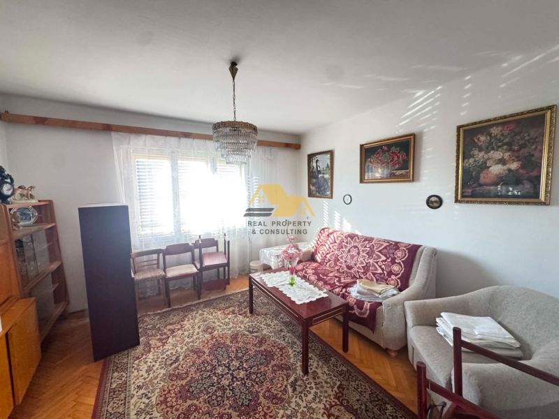 Living room in a family house with comfortable furniture and wooden decor flooring.