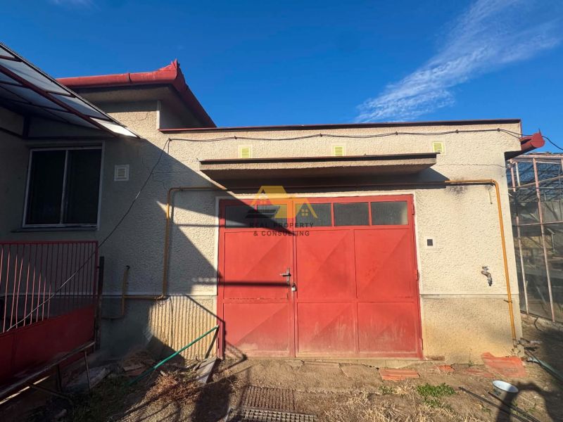 A family house in Dvory nad Žitavou with a red garage door on the street Dvory nad Žitavou.