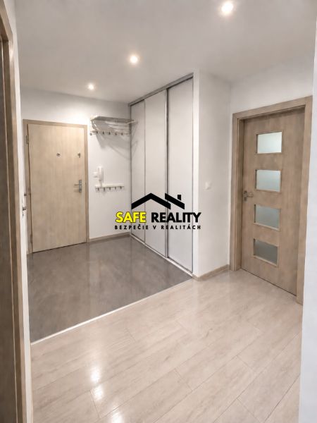 Interior of a 3-room apartment with a wooden decor floor and a built-in wardrobe.