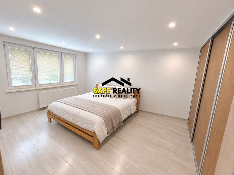 Bedroom in a 3-room apartment with a bed, wardrobe, and floor with a wooden decor.