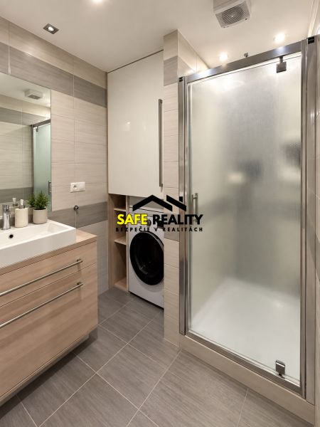 Bathroom in a 3-room apartment with a sink, shower, and washing machine.
