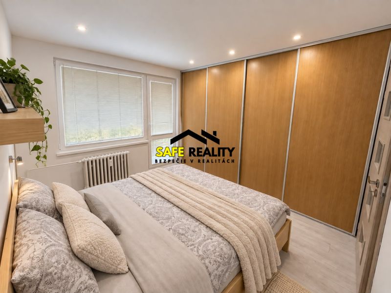 Bedroom in a 3-room apartment with a large wardrobe and bed, floor with wooden decor.