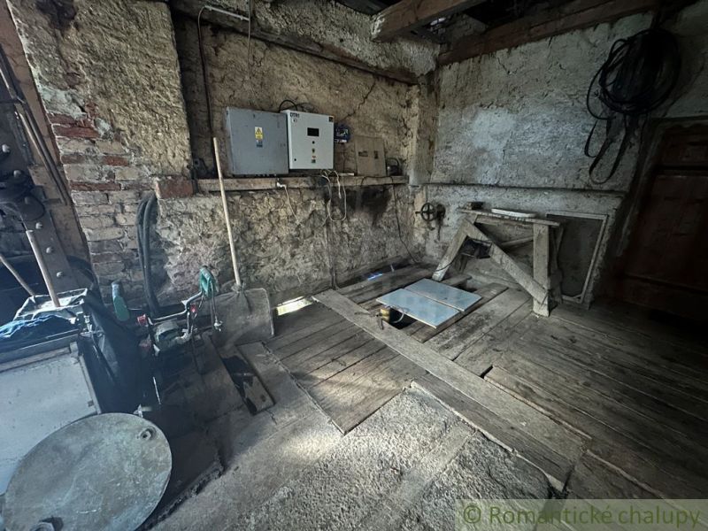 A rustic room in a family house with wooden and stone elements.