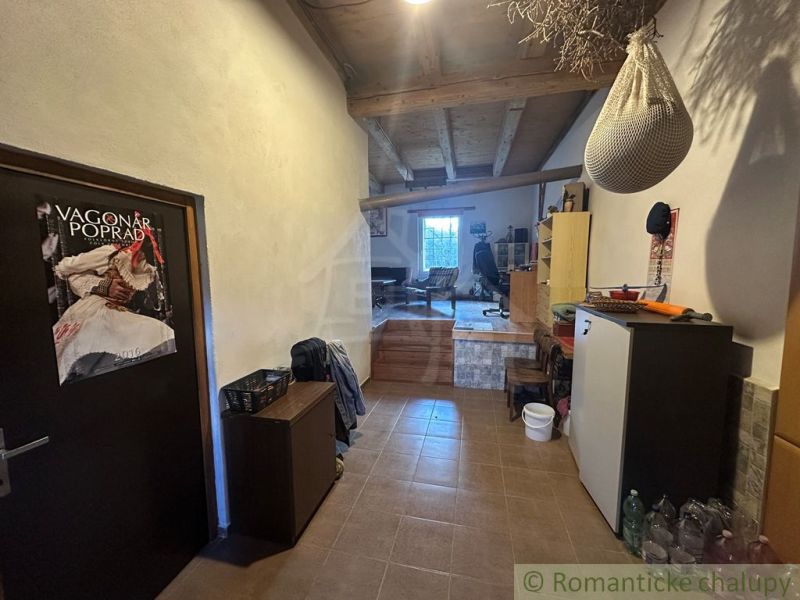 Interior of a family house with a beamed ceiling, furnished with furniture and decorations.