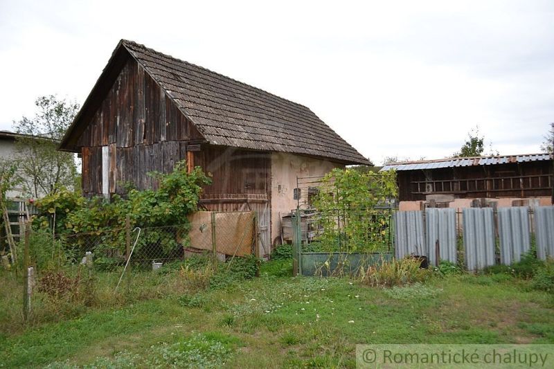 A family house in Nemcovce with older wooden cladding and a garden.