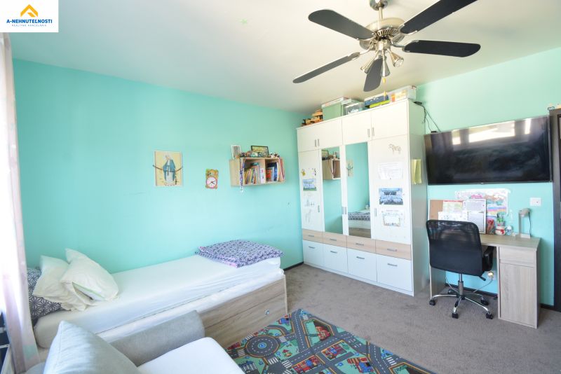 Children's room in a 3-room apartment with a wardrobe, desk, and bed.
