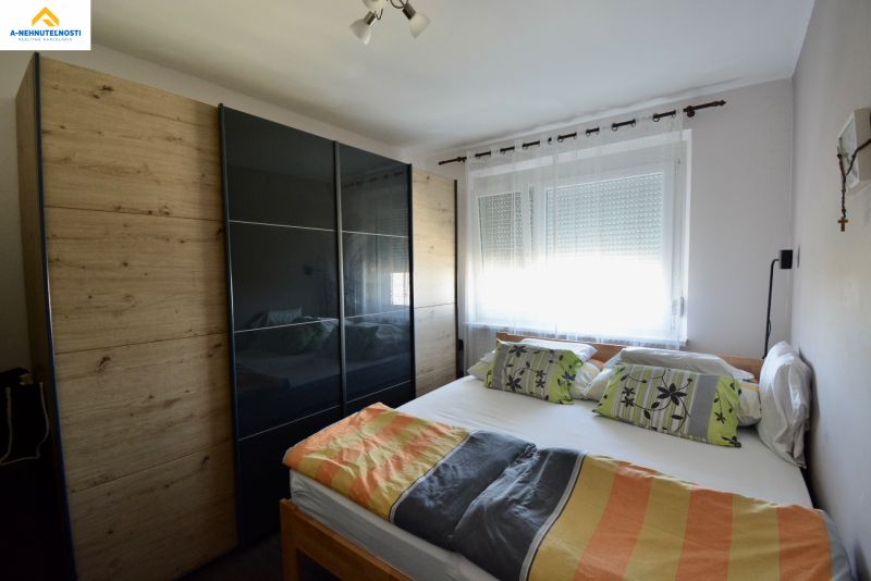 Bedroom with a double bed and a large wardrobe in a 3-room apartment.