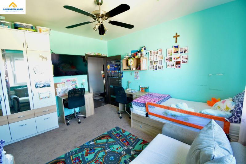 Children's room in a 3-room apartment with a soft carpet and furniture.