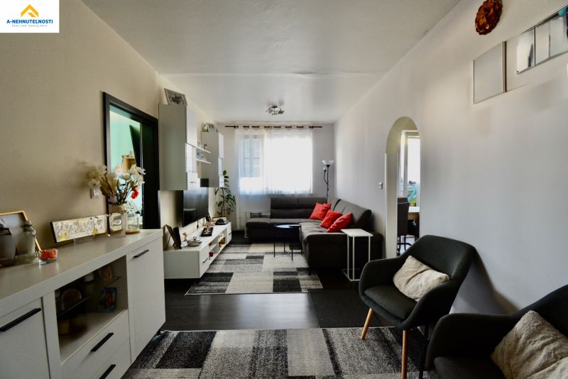 Living room in a 3-room apartment with modern furniture and a comfortable sofa set.