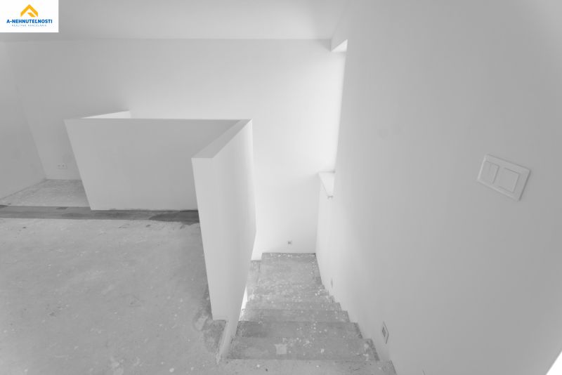 Concrete stairs leading to the lower floor in a family house.