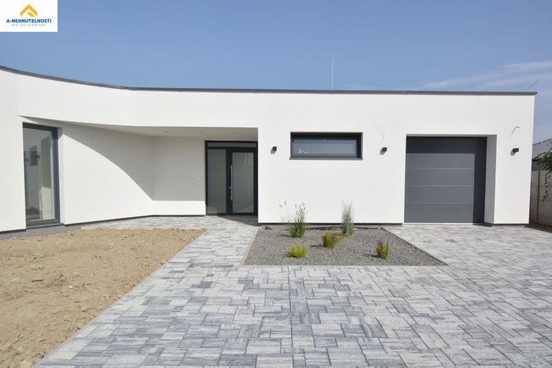 Family house on Kráľovianky in Šamorín with paving and a minimalist garden.