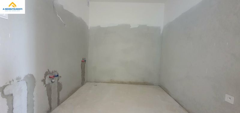 Uncounted room with plumbing preparation in a 3-room apartment.