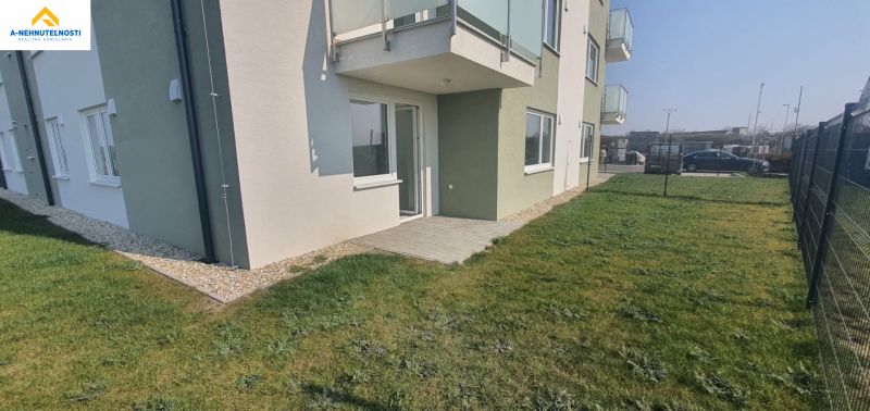 The exterior of a newly built 3-room apartment in Šámot, Šamorín with a terrace and lawn.