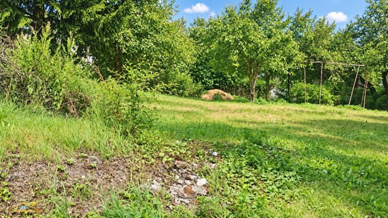 Green residential plots in Staškov surrounded by trees and grassy areas.
