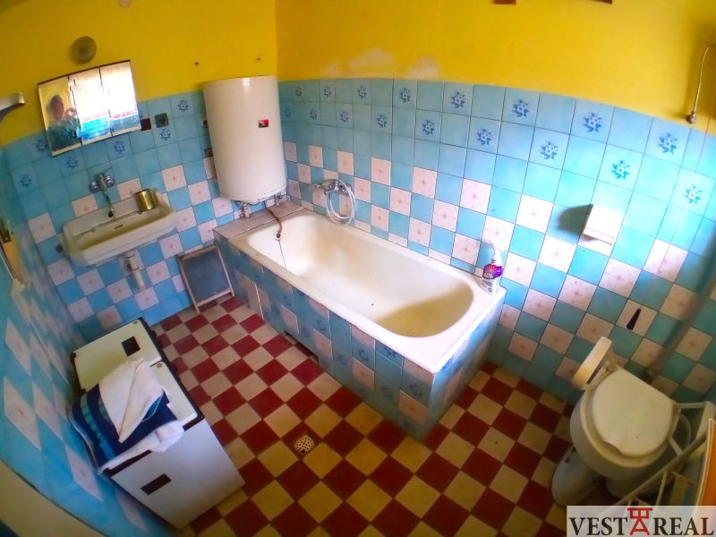 A bathroom in a family house with tiles and blue tiles.