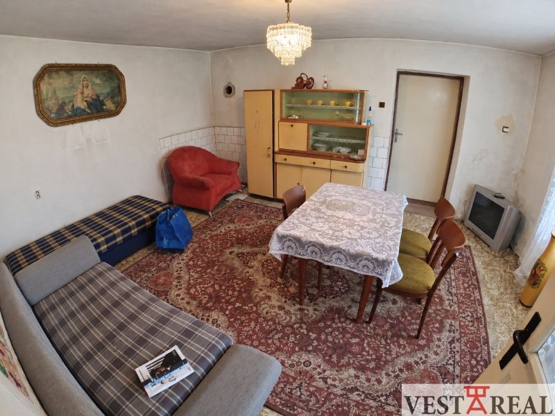 Living room in a family house with an upholstered sofa and a coffee table.