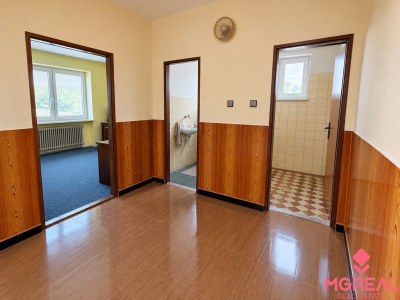 Interior of a family house with a wooden decor floor and entrances to rooms.