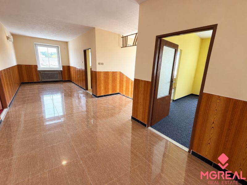 Interior of a family house with tiled flooring and wooden wall cladding.