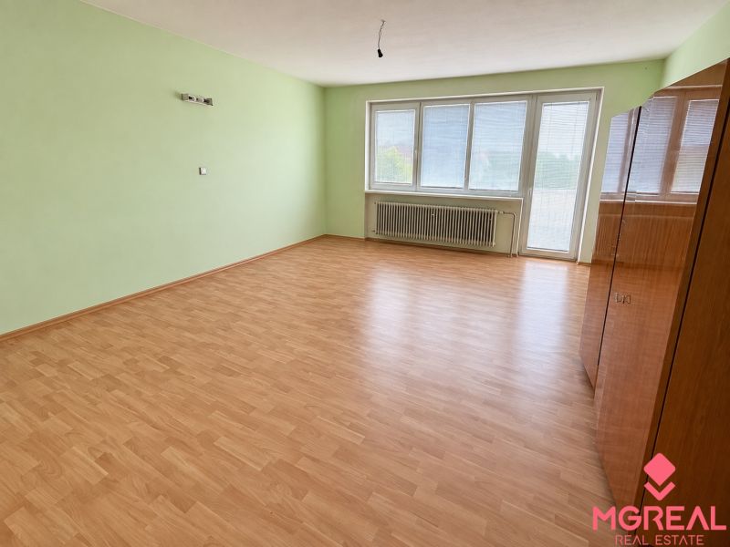 A room with a wooden decor floor and light green walls, Family house.