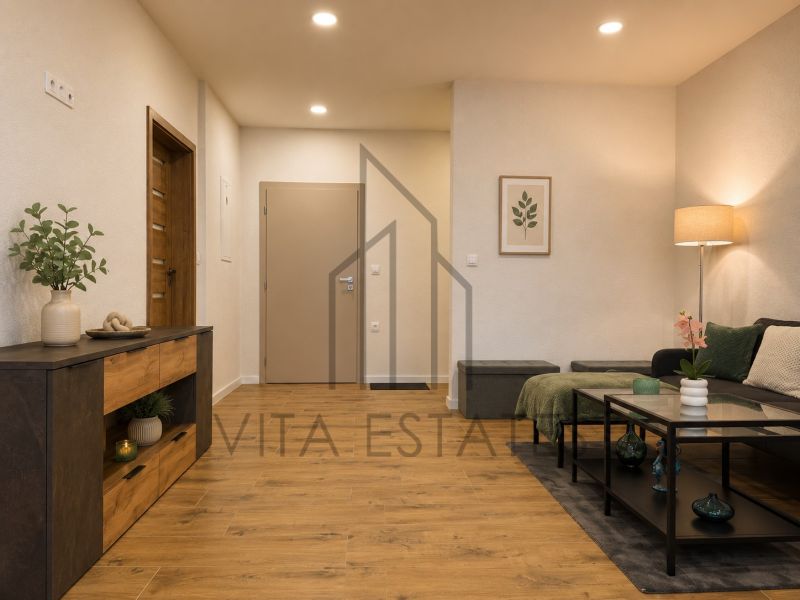 Living room in a three-room apartment with a light wood-patterned floor and furniture.