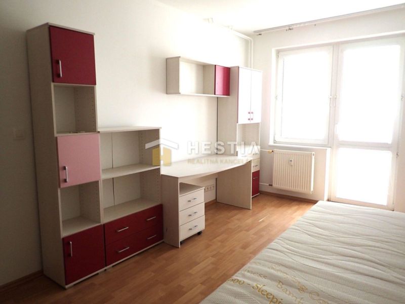 A bright room in a 3-room apartment with furniture and flooring in wood decor.