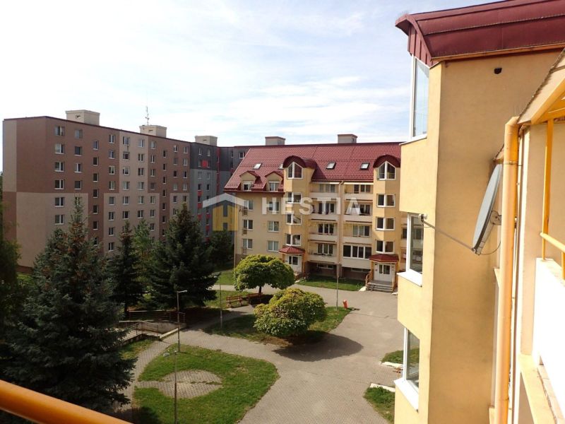 View from a 3-room apartment in Senica of residential buildings and greenery.