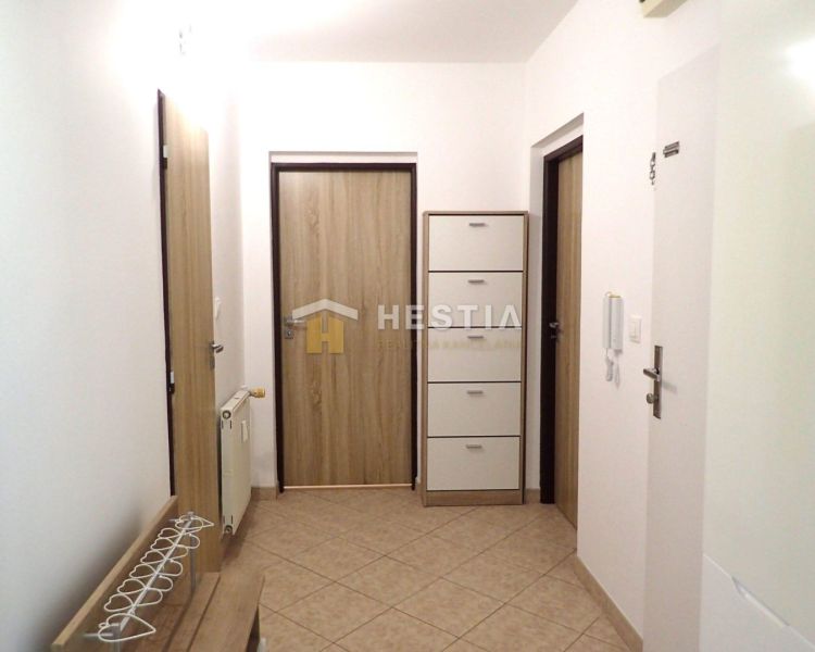 A hallway in a 3-room apartment with tiles and storage space.