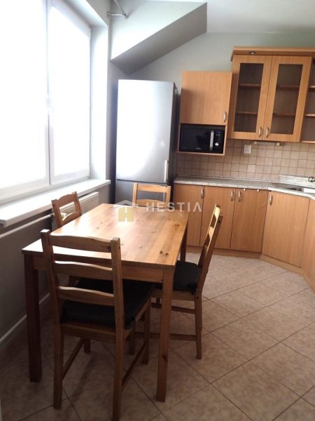 A kitchen in a 3-room apartment with a dining table and light furniture.