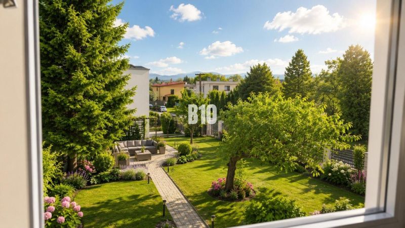 View from the window of a family house in Martin onto a garden with greenery and a path.