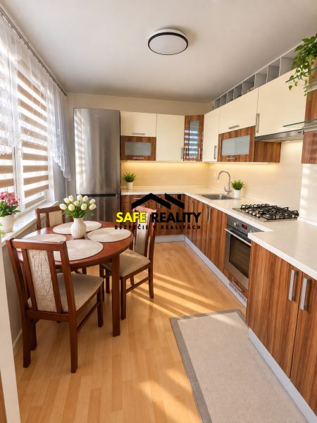 A kitchen in a 3-room apartment with furnishings and flooring in a wood decor.