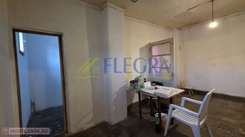 A room in a family house with a plastic chair and a simple table.