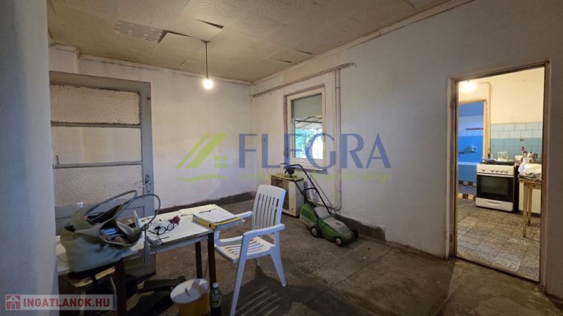 Interior of a family house with an unused room and basic furnishings.