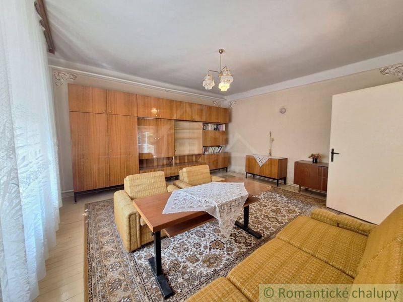 Living room of a family house with retro furniture and a wooden decor floor.