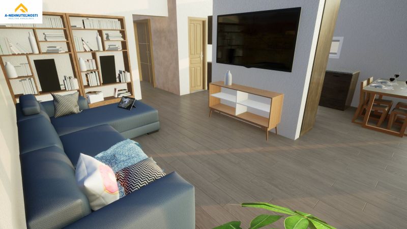 Living room in a family house with a sofa, bookshelf, TV, and wooden decor flooring.