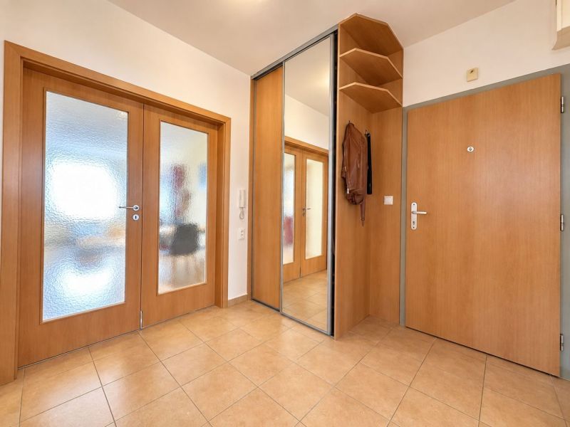 Bathroom in a 3-room apartment with a toilet, mirror, and decorative elements.