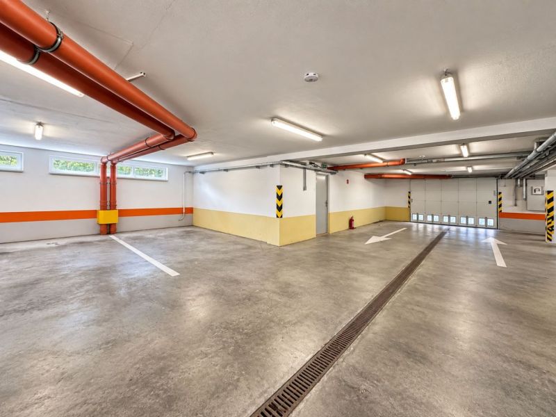 Parking spaces in a closed garage, Bratislava - Ružinov, with orange details and stripes.