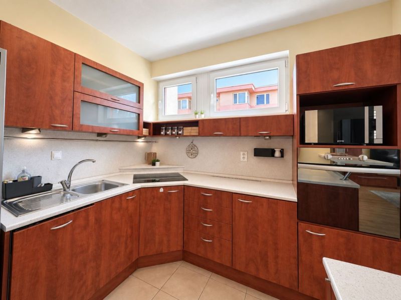 Bedroom in a 3-room apartment with a double bed, a large wardrobe, and a floor with a wooden decor.